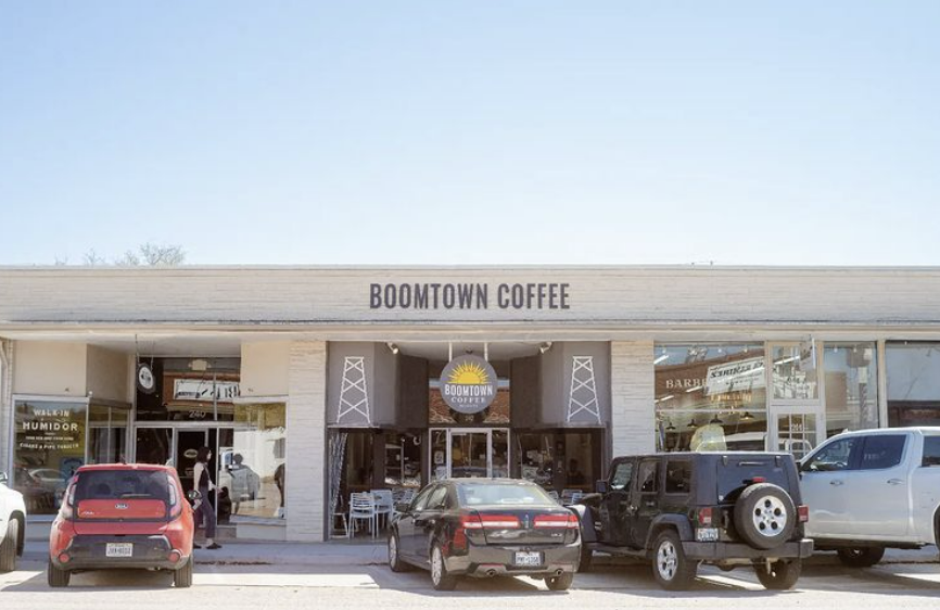 Exterior of Boomtown Coffee Company with cars parked on street